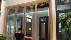 wood color Aluminium soundproof tri fold doors/glass folding double panel door on China WDMA on China WDMA